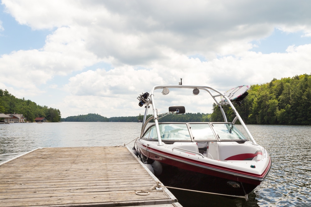 A Wakeboard Boat At A Wooden Dock In The Muskokas