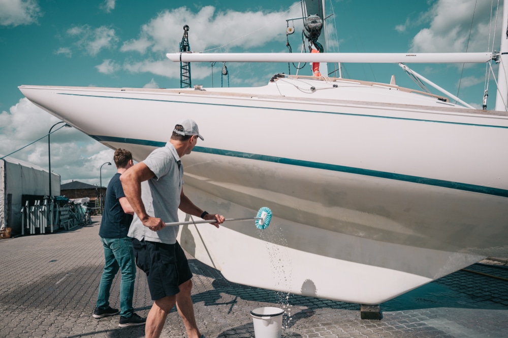 Father And Son Cleaning A Boat