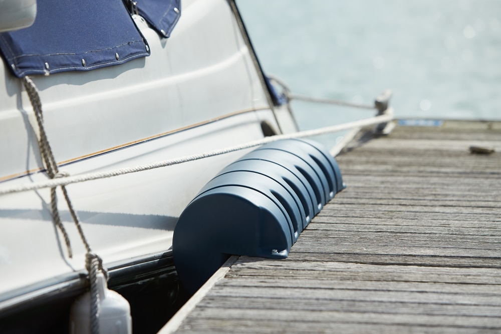 Long pier blue fenders for a boat and dockside for protection