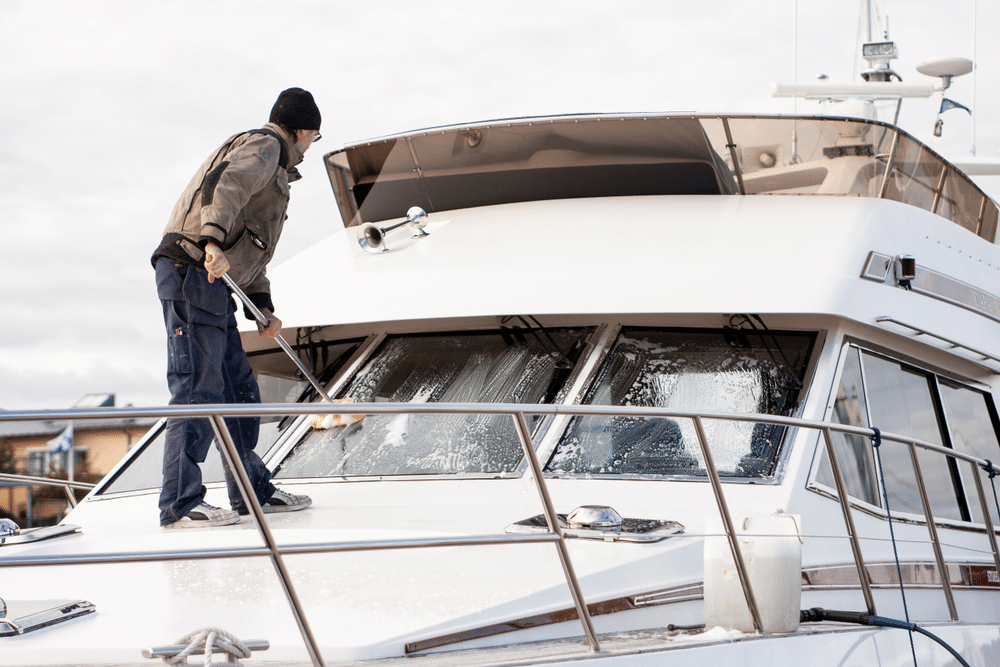 Man at work washing a boat at the marina