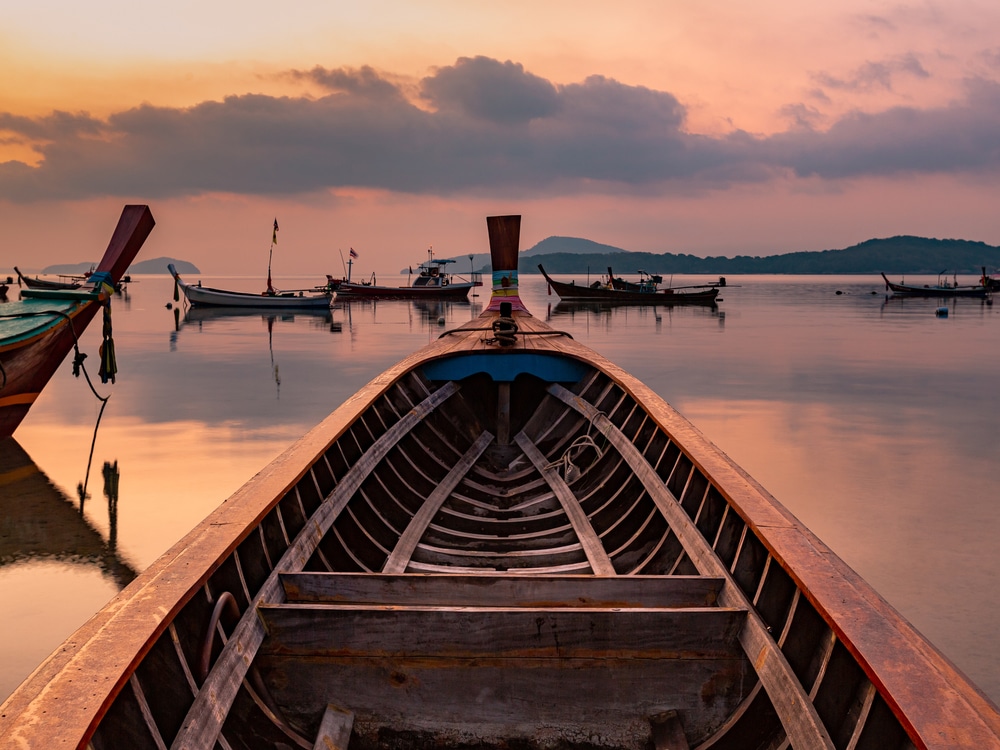 Silhouette Bow Of Long Tail Boat Against The Twilight Background