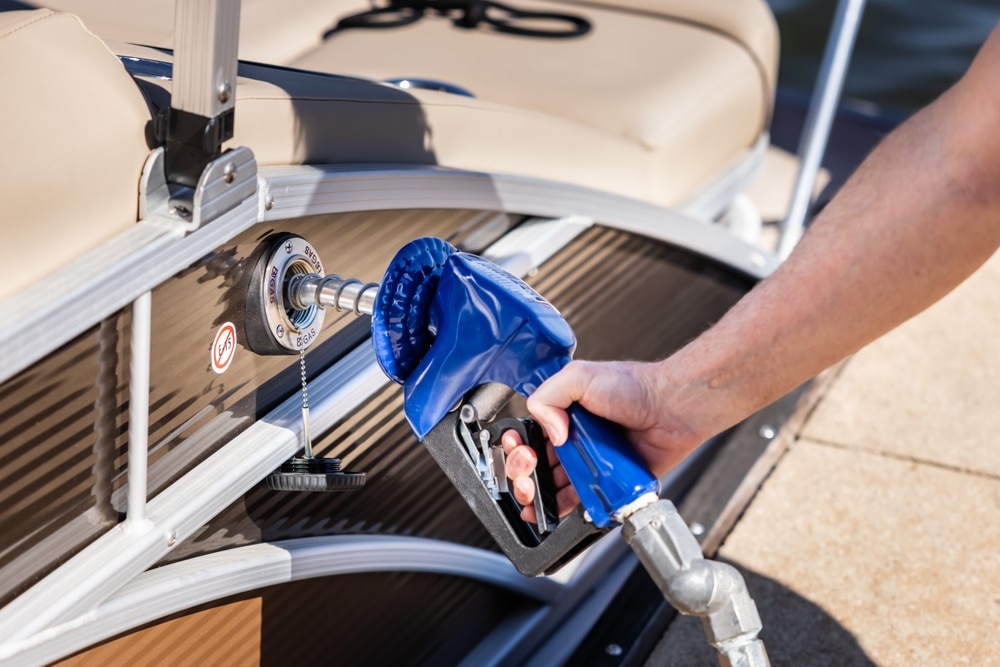 Man Refueling Boat At Marina Gas Pump Nozzle Filling Pontoon