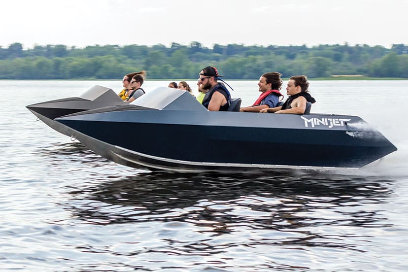 people enjoying small jet boating in water