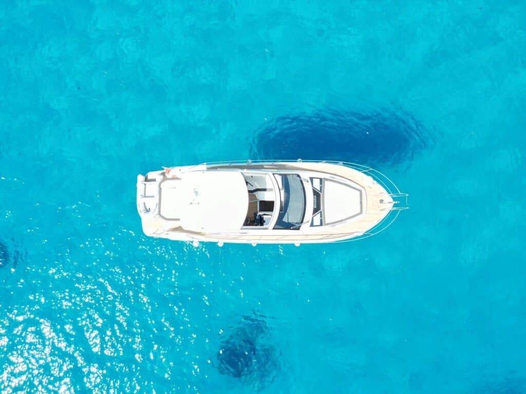 white boat with wide boat in water