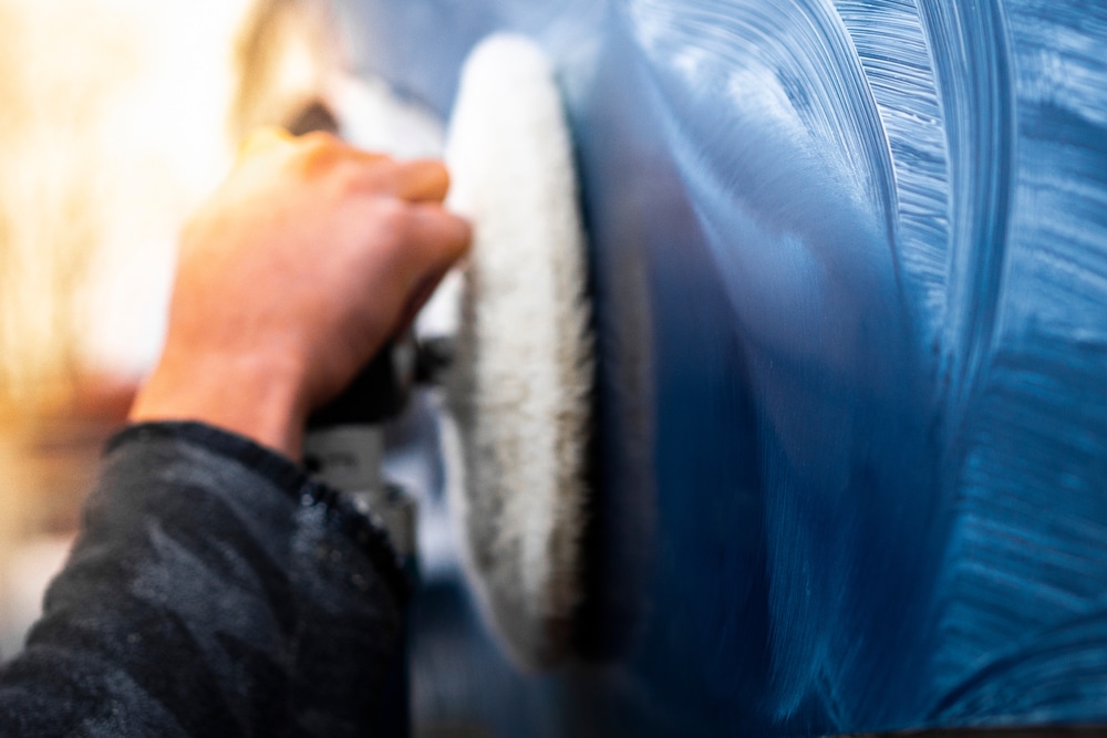 A close view of a person waxing boat