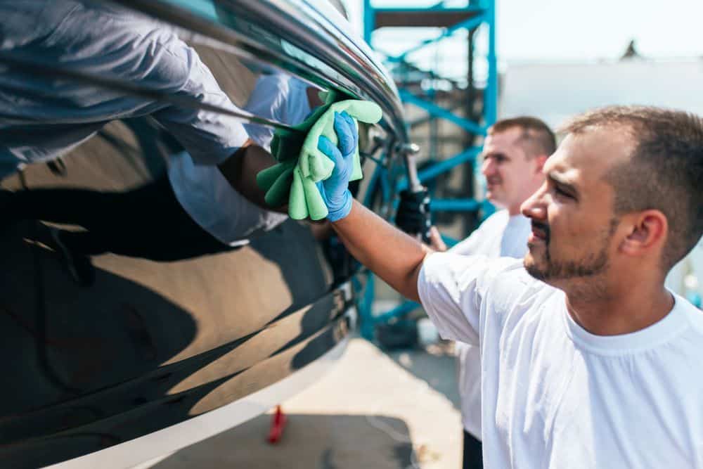 A view of a person cleaning boat with a cloth