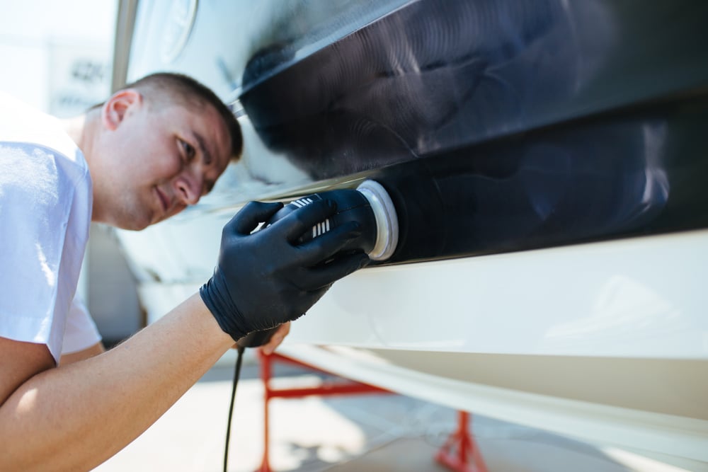 A view of a person polishing a boat