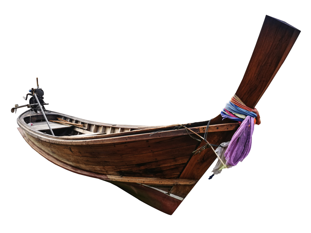 A view of a wooden boat with its long tail visible