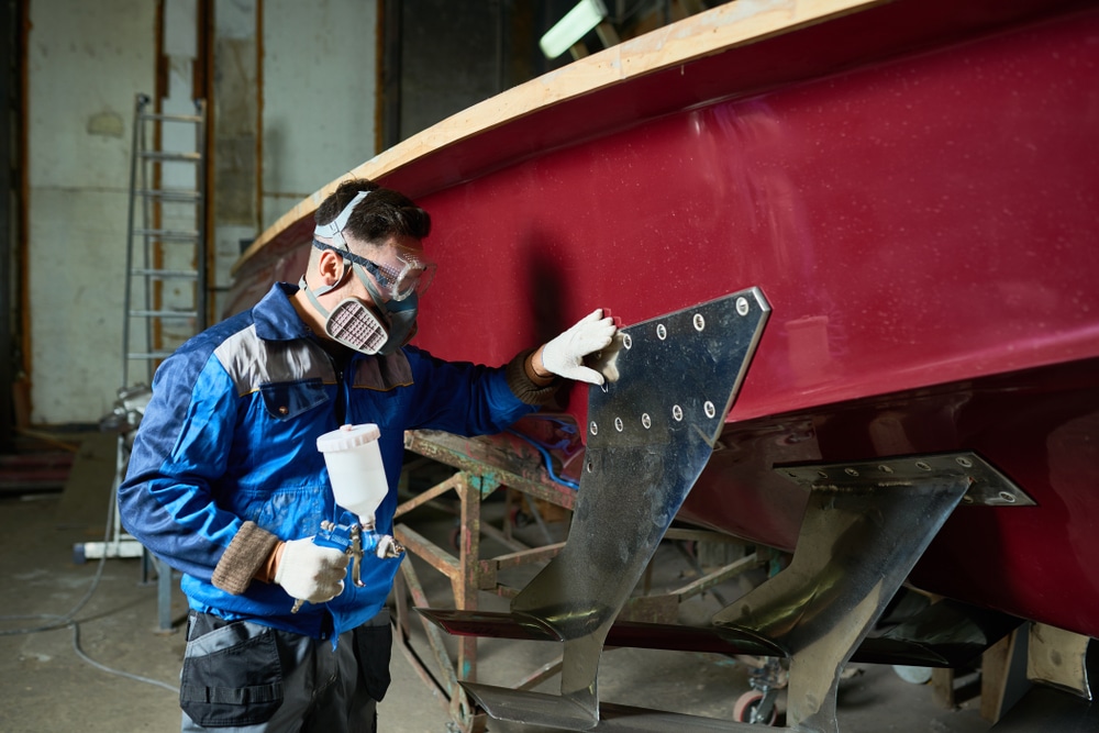 Side View Portrait Of Unrecognizable Worker Wearing Protective Mask Painting