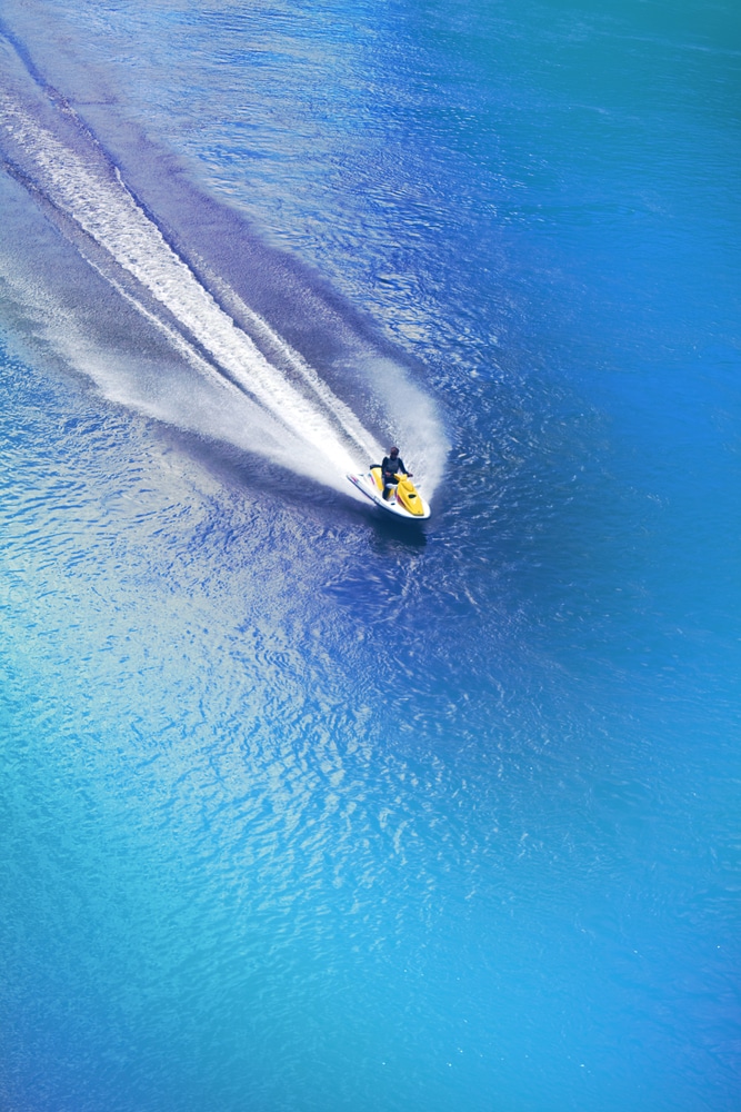 Jet Ski Racing On A Blue Water Background