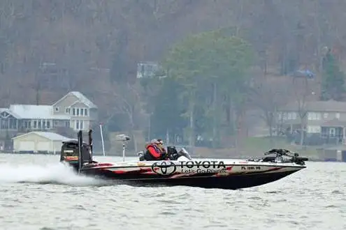 A far away view of a bass boat in the sea