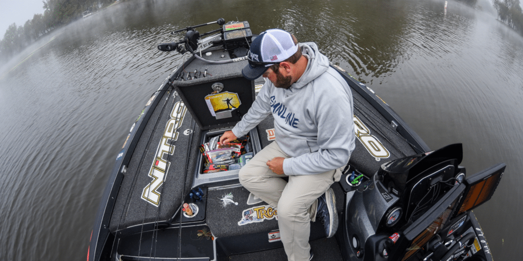 A top view of a person taking out a snack from the bass boat