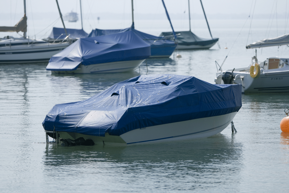 A view of a boat with a boat cover in the sea