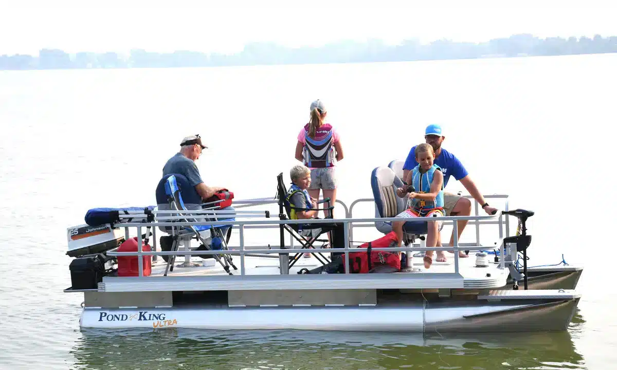 A view of a family sitting inside a pontoon family boat