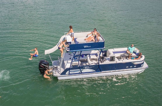 A view of people sitting on a pontoon boat in sea