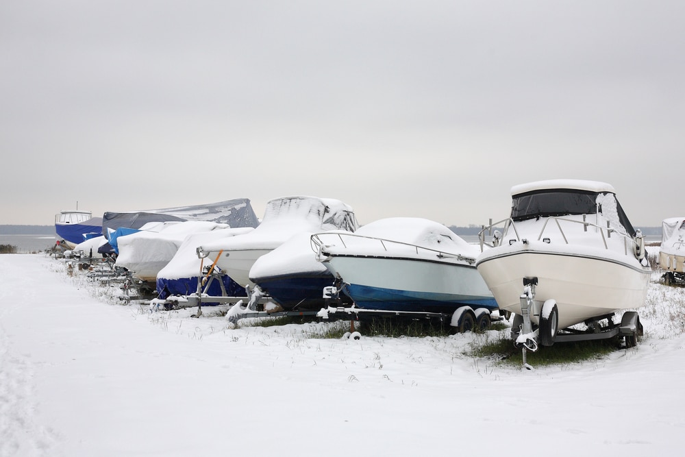 A view of a boat winterized in the snow