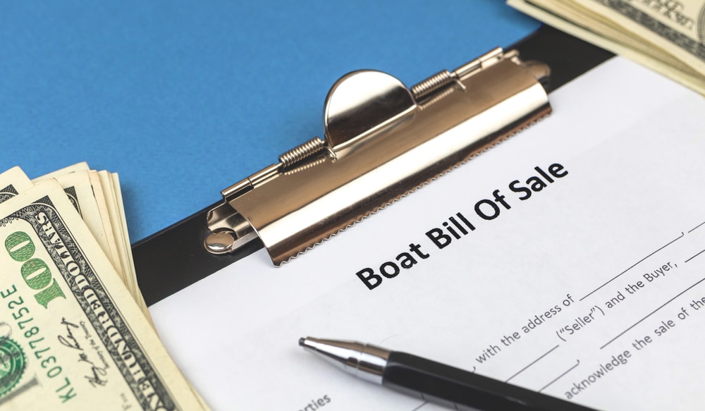 A view of a contract of boat lease with money on the side