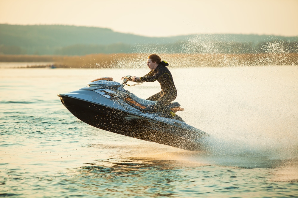 A view of a guy riding on watercraft boat