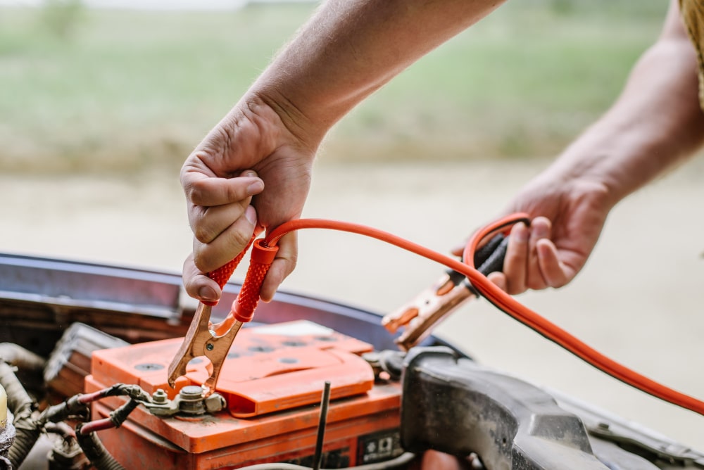 A view of a person dealing with boat battery with an electric shock tool