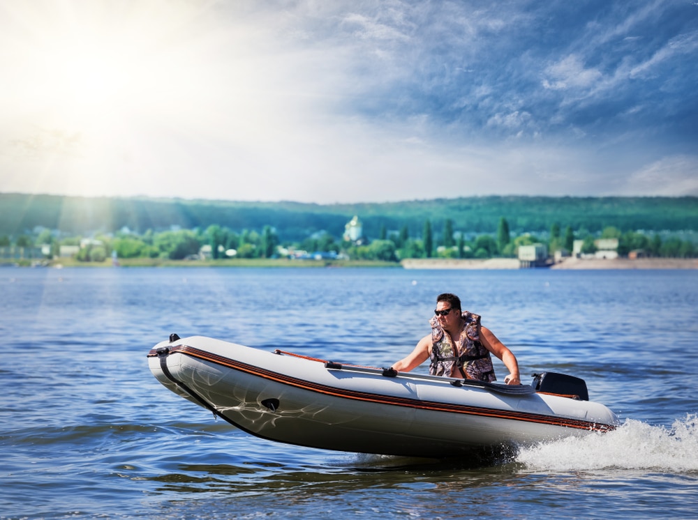 A view of a person riding an inflatable boat on a lake