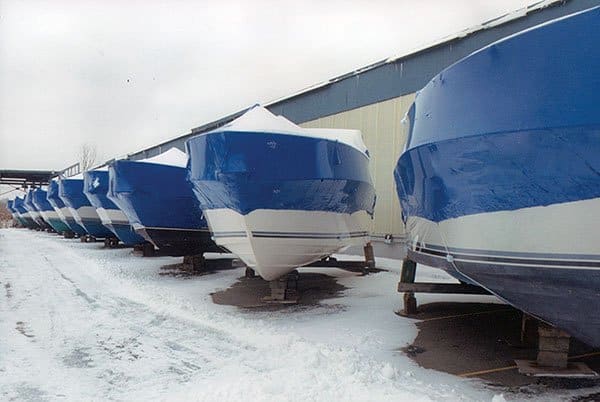 A view of boats covered and winterized in cold snow