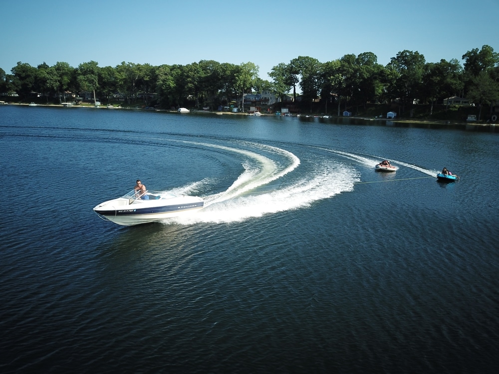 A view of people skiing on boats in a lake