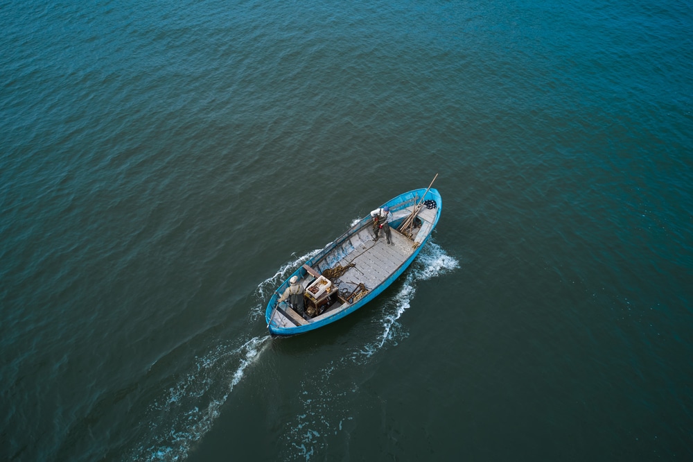 An overhead view of a boat floating in sea