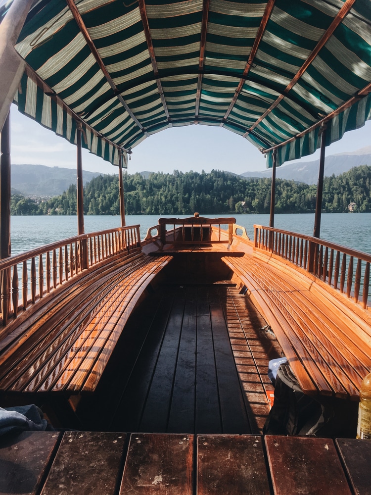 A Vertical Shot Of A Boat With A Wooden Seat